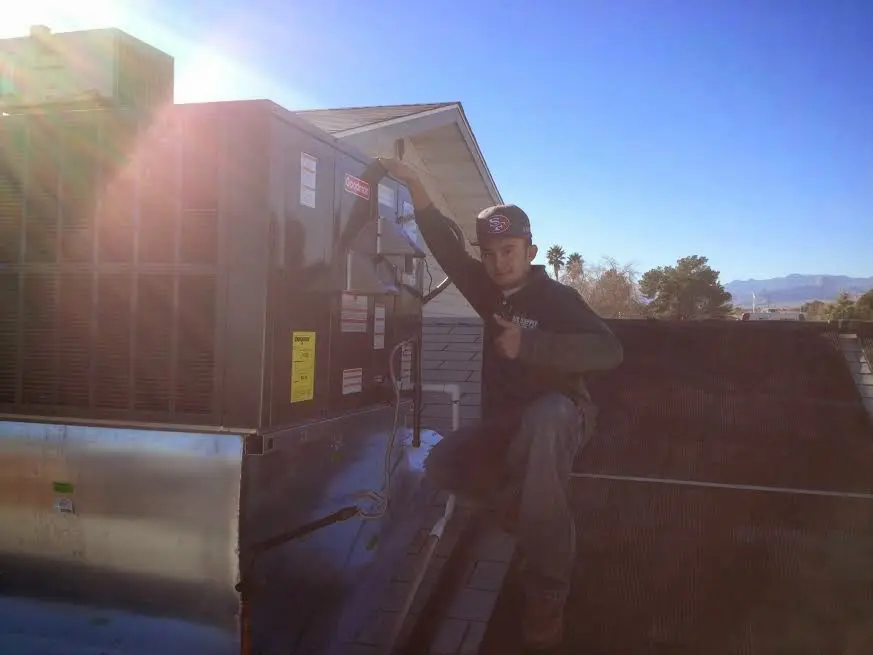 HVAC technician performing HVAC Inspection on a rooftop unit in Claremore